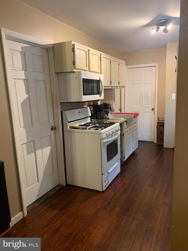 kitchen featuring white cabinets, white appliances, sink, and dark hardwood / wood-style flooring