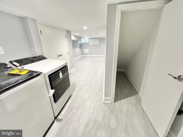 kitchen with white cabinets and washer and dryer