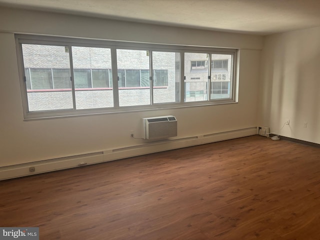 unfurnished room featuring a wealth of natural light and dark hardwood / wood-style flooring