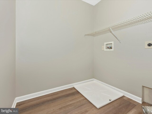 clothes washing area featuring washer hookup, hardwood / wood-style flooring, and electric dryer hookup