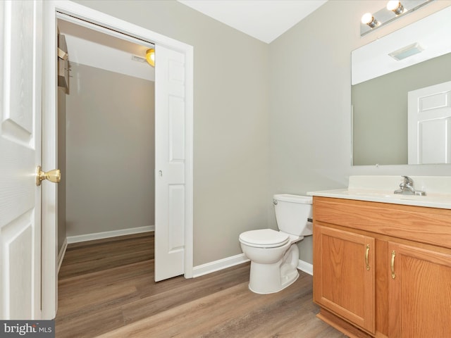 bathroom with vanity, hardwood / wood-style floors, and toilet