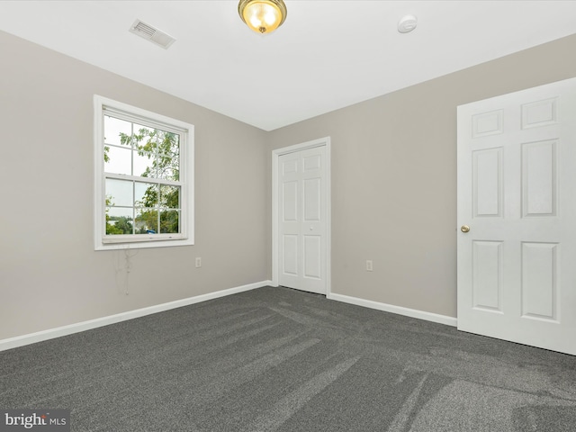 empty room with dark carpet