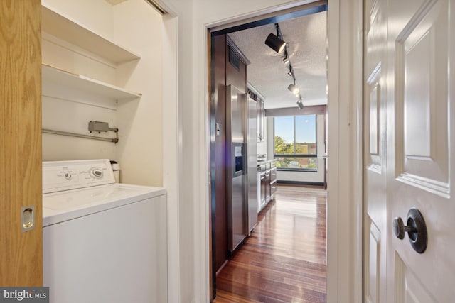 laundry area with washer / clothes dryer, a textured ceiling, dark wood-type flooring, and rail lighting