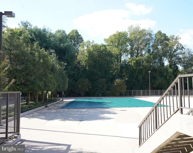 view of swimming pool with a patio area