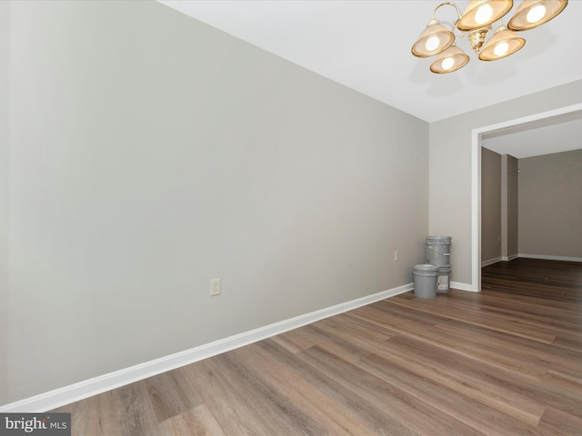 interior space with hardwood / wood-style flooring and a chandelier