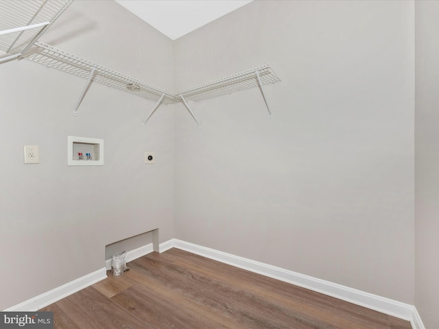 washroom with hookup for a washing machine, hardwood / wood-style flooring, and electric dryer hookup