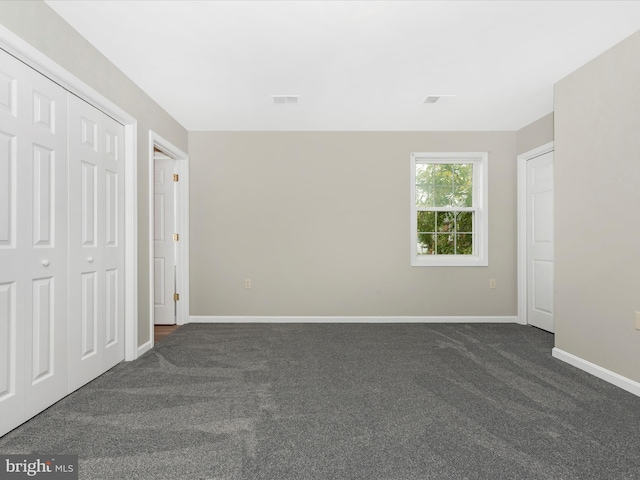 unfurnished bedroom featuring dark colored carpet