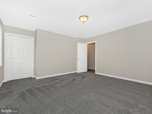 empty room with dark colored carpet