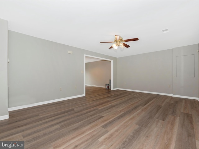 spare room featuring ceiling fan and dark hardwood / wood-style flooring