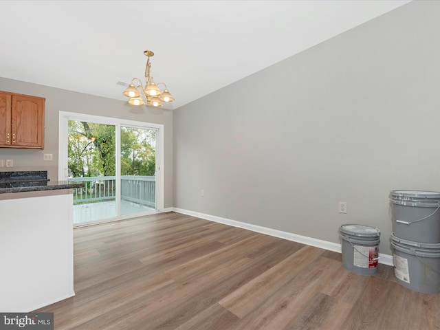 kitchen with a notable chandelier, light hardwood / wood-style flooring, and hanging light fixtures