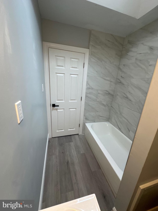 bathroom featuring hardwood / wood-style floors and a washtub