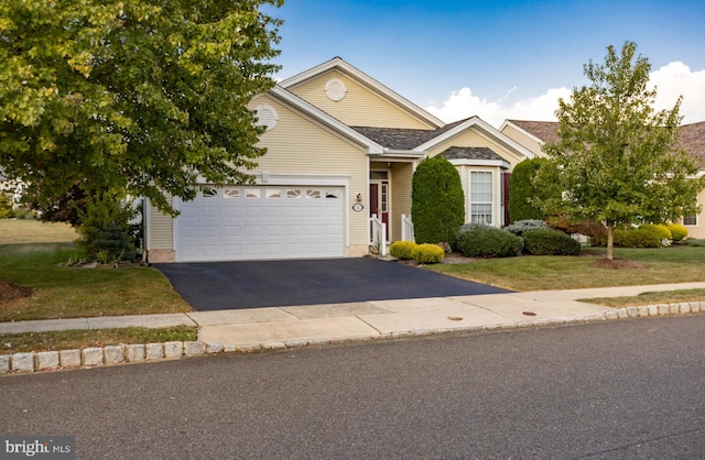 view of front of house featuring a front yard and a garage