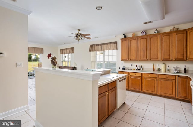 kitchen featuring ceiling fan, light tile patterned floors, ornamental molding, dishwasher, and a center island