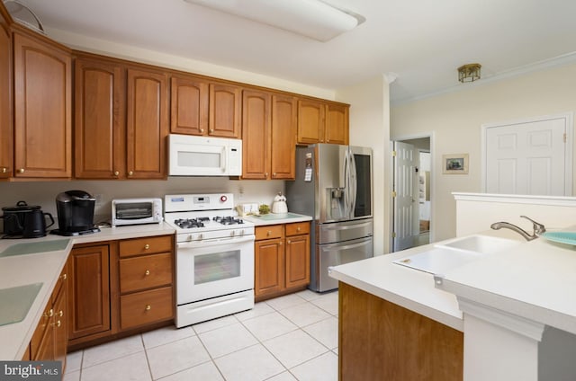 kitchen with light tile patterned floors, sink, and white appliances