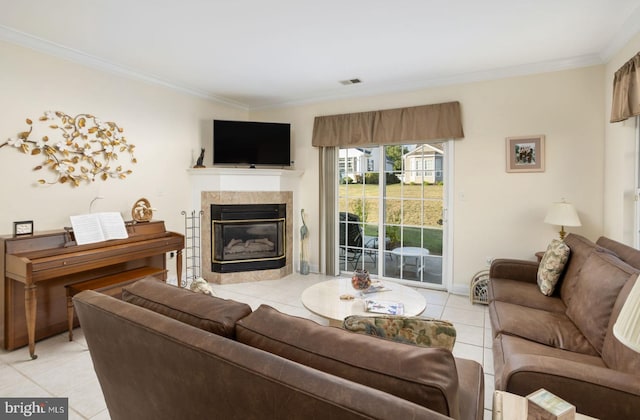 tiled living room featuring crown molding and a tiled fireplace