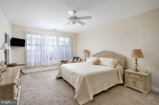 bedroom featuring ceiling fan and light colored carpet