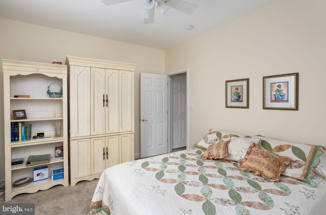 bedroom featuring ceiling fan, light colored carpet, and a closet