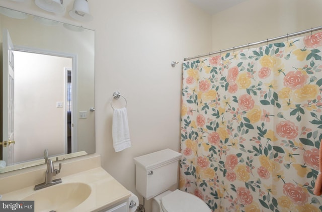 bathroom featuring vanity, toilet, and a shower with curtain