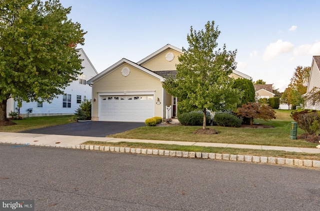 view of front of house featuring a garage and a front lawn