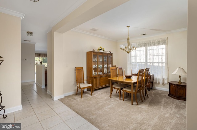 carpeted dining room featuring a healthy amount of sunlight, ornamental molding, and a notable chandelier