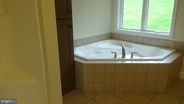 bathroom featuring tiled bath and tile patterned floors