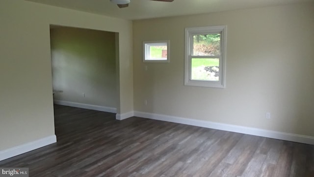 spare room featuring ceiling fan and dark wood-type flooring