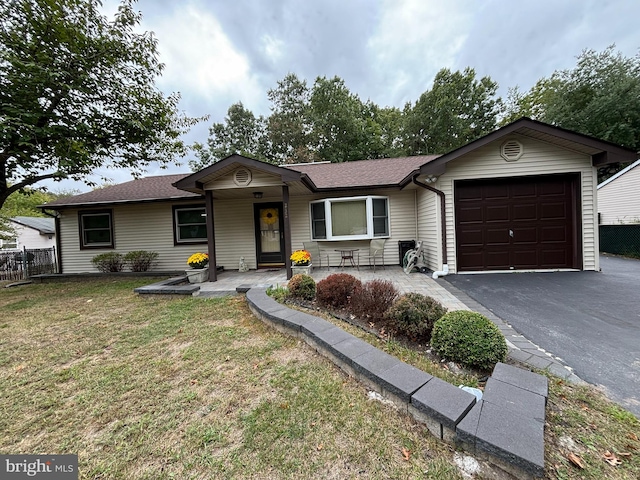 ranch-style house with a garage and a front yard