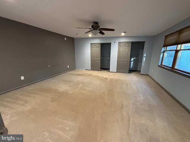 unfurnished bedroom with light carpet and ceiling fan