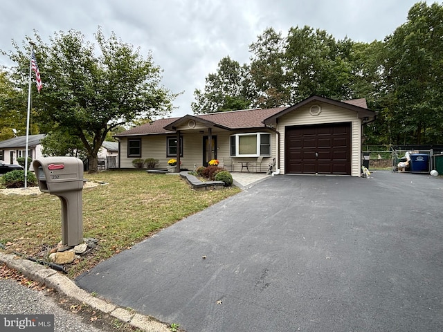 ranch-style house featuring a garage and a front yard