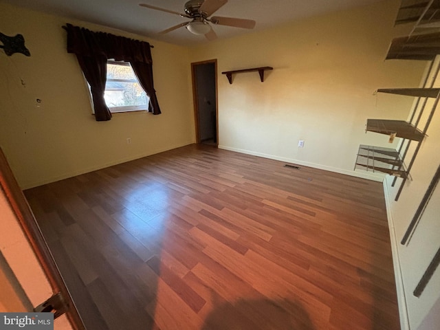 empty room with wood-type flooring and ceiling fan