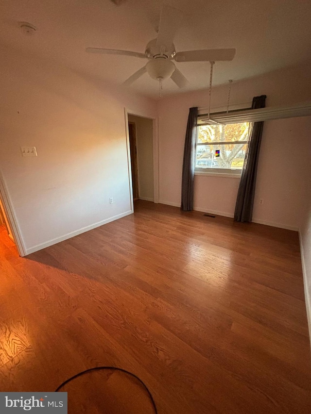 spare room featuring hardwood / wood-style flooring and ceiling fan