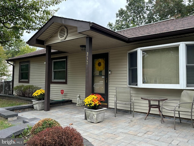 view of exterior entry featuring a patio