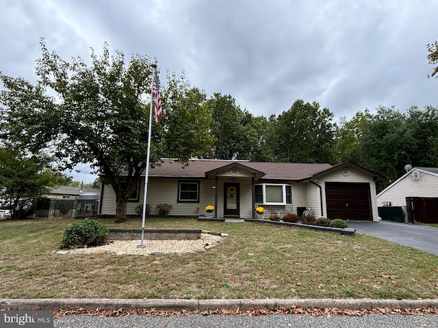 ranch-style home with a garage and a front lawn