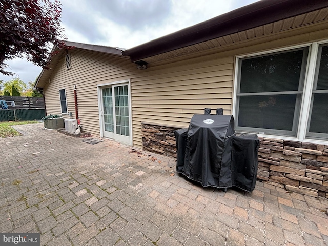 view of patio featuring area for grilling and cooling unit