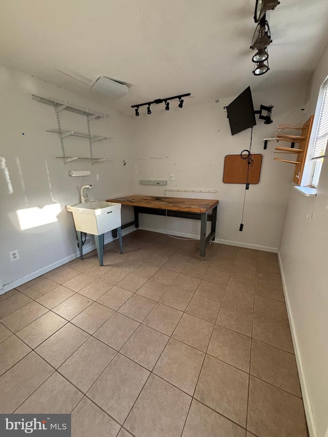 interior space featuring light tile patterned floors and sink