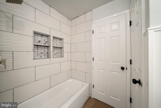 bathroom with shower / bath combination and wood-type flooring