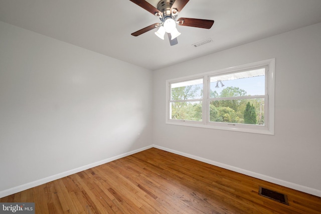 unfurnished room featuring ceiling fan and hardwood / wood-style flooring