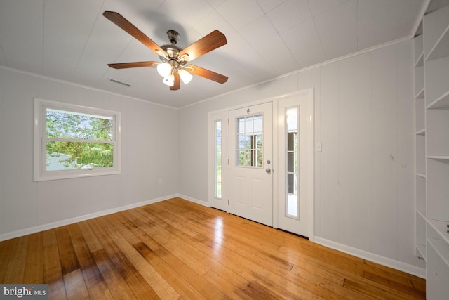 entryway featuring ornamental molding, ceiling fan, and wood-type flooring