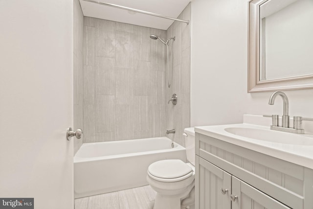 full bathroom with tiled shower / bath combo, vanity, and toilet