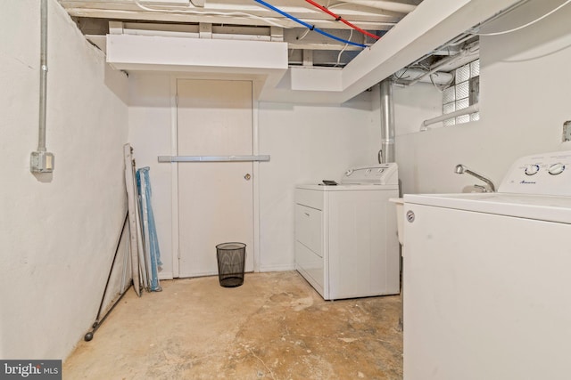 clothes washing area featuring washer and dryer