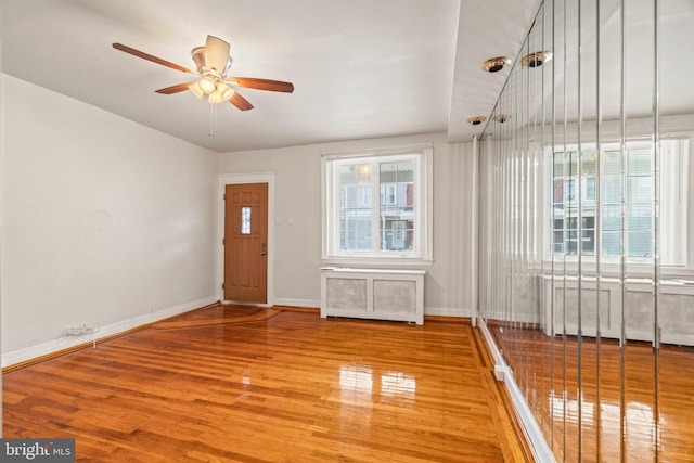 spare room featuring ceiling fan and light hardwood / wood-style floors