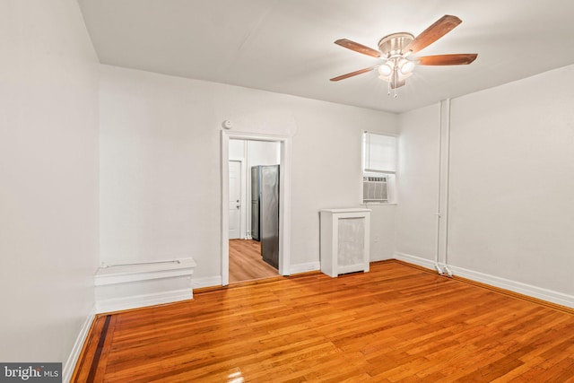 empty room featuring ceiling fan and light hardwood / wood-style floors