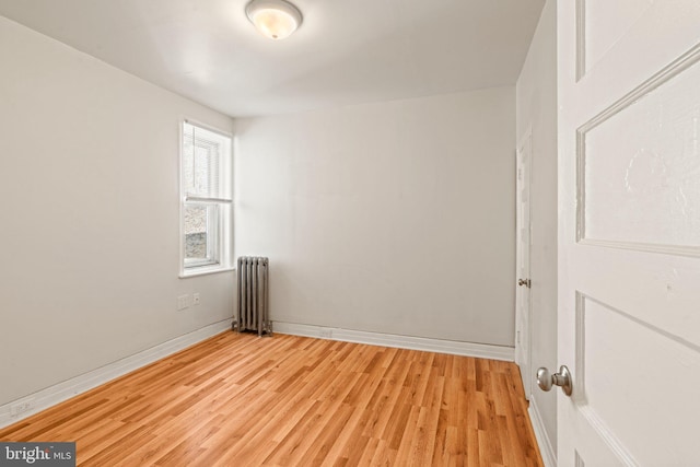 spare room with light hardwood / wood-style flooring and radiator