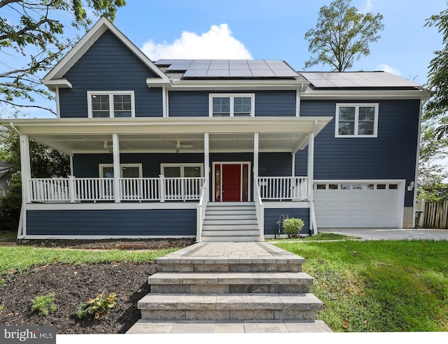 view of front facade with a garage, solar panels, and covered porch