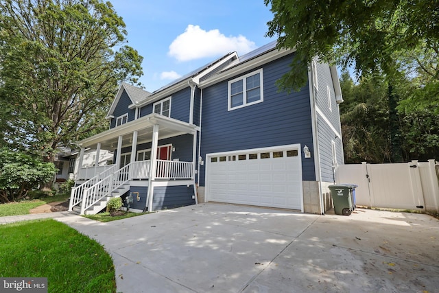 view of front facade featuring covered porch and a garage