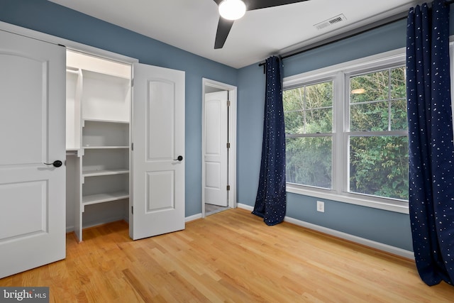 unfurnished bedroom with ceiling fan and light hardwood / wood-style flooring