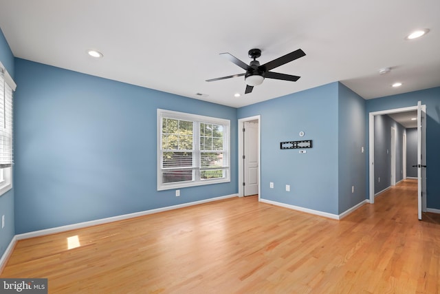 empty room with light hardwood / wood-style floors and ceiling fan