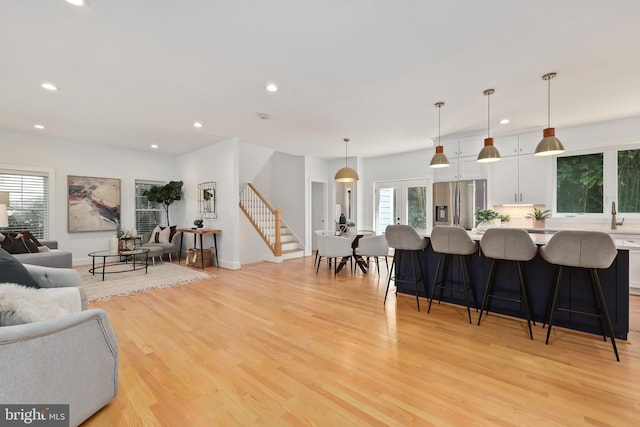 living room with light hardwood / wood-style flooring and plenty of natural light