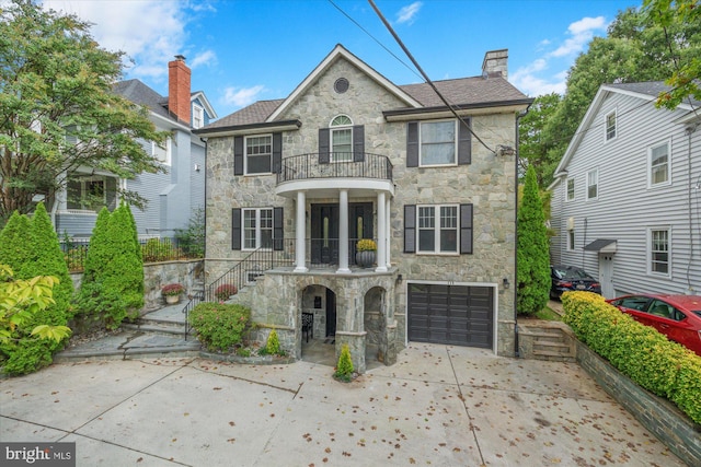 view of front of house featuring a garage and a balcony