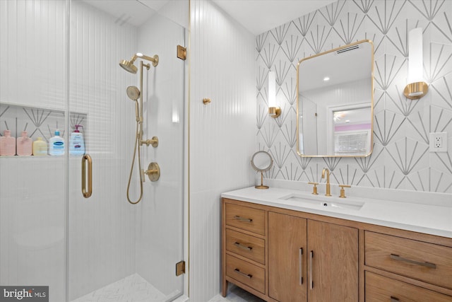 bathroom featuring walk in shower and vanity